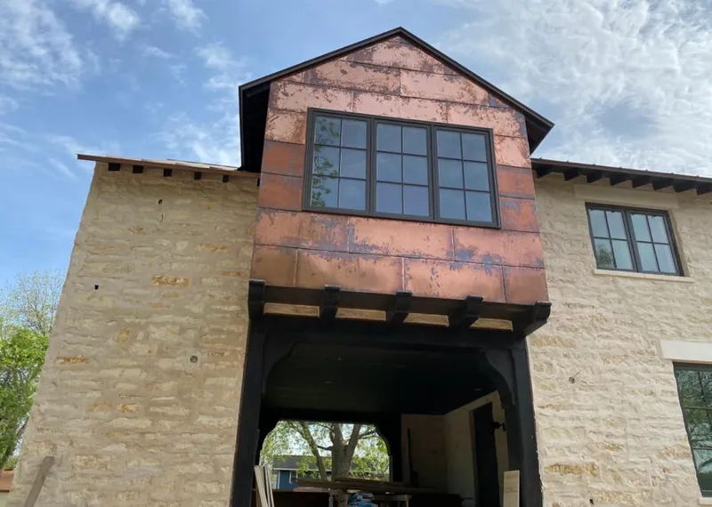 Copper metal panel facade on a stone building for Skylight Installation in Iron Mountain