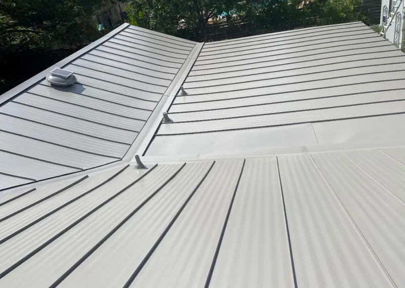 Solar attic fan installed on a metal roof for Roof Ventilation in Iron Mountain